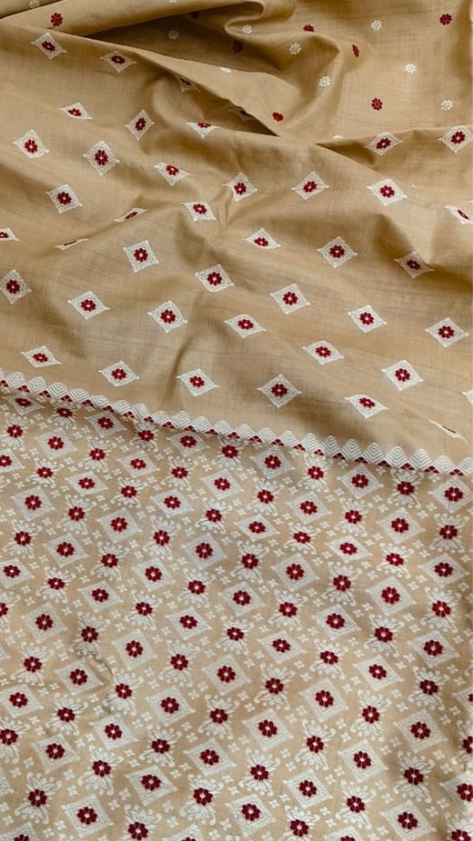 Side view of golden-beige Assam Muga silk saree with ivory geometric motifs and red floral accents.