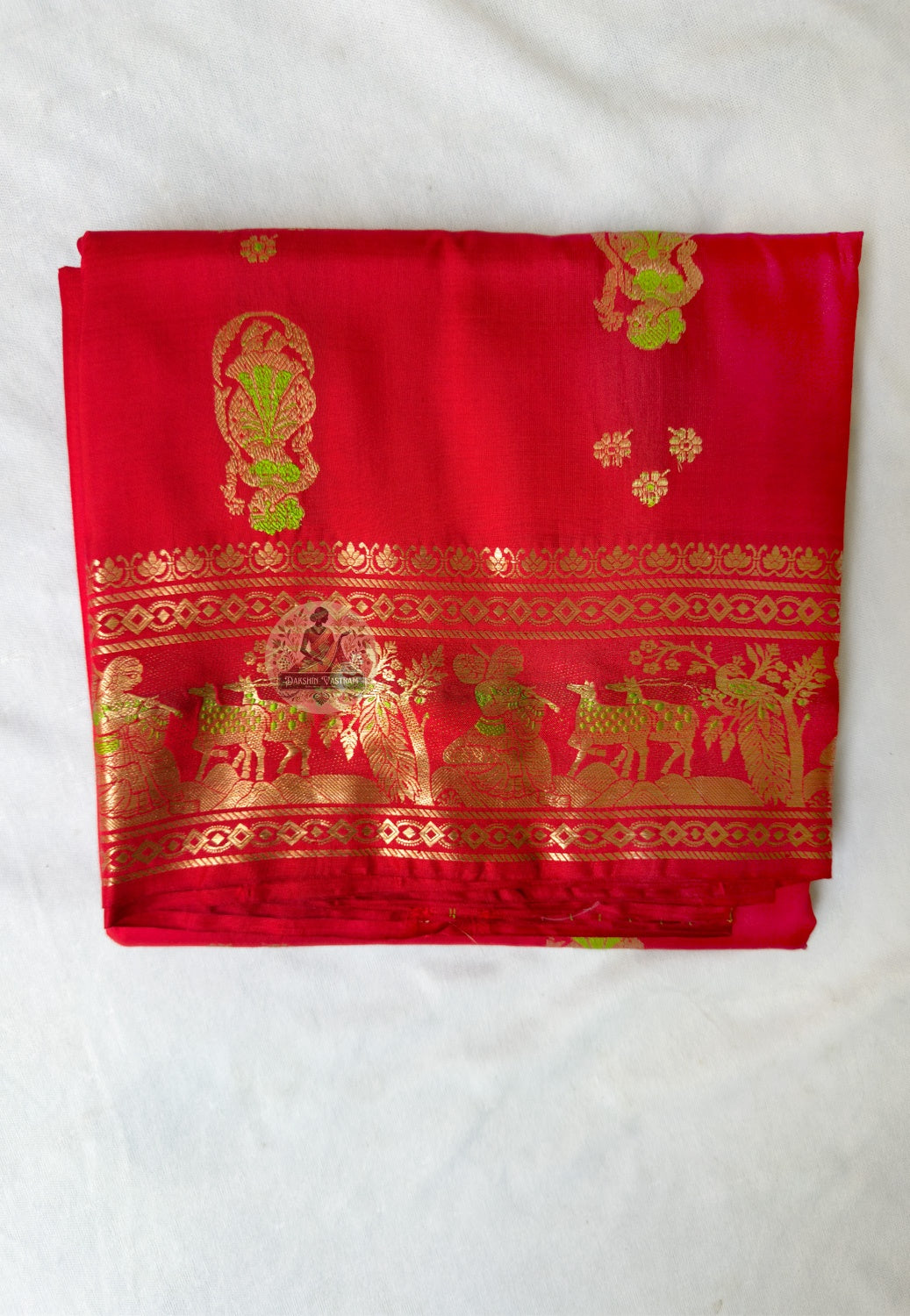 Full flat-lay of Swarnachari pure silk saree with golden zari recovery border, continued narrative pallu, rhythmic buti field, and matching unstitched blouse piece, West Bengal handloom