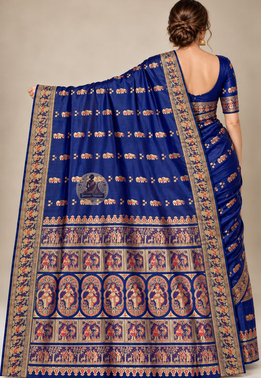 Rear view of royal blue Swarnachari silk saree with the figurative pallu draped over the shoulder