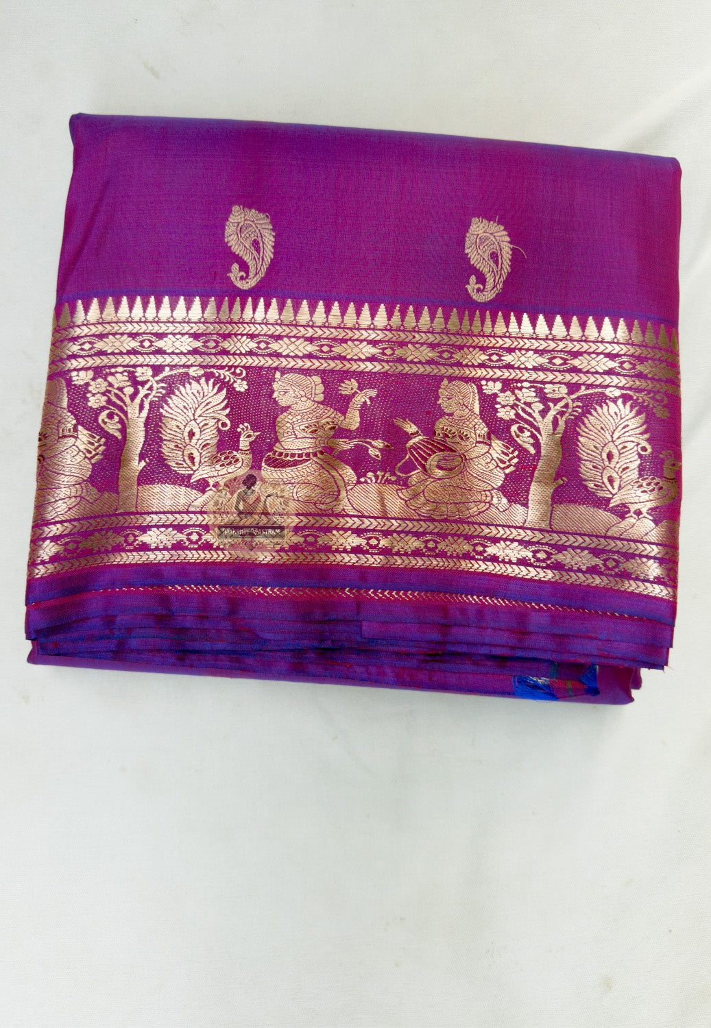 Close up of small scattered motifs on the magenta Swarnachari silk saree body