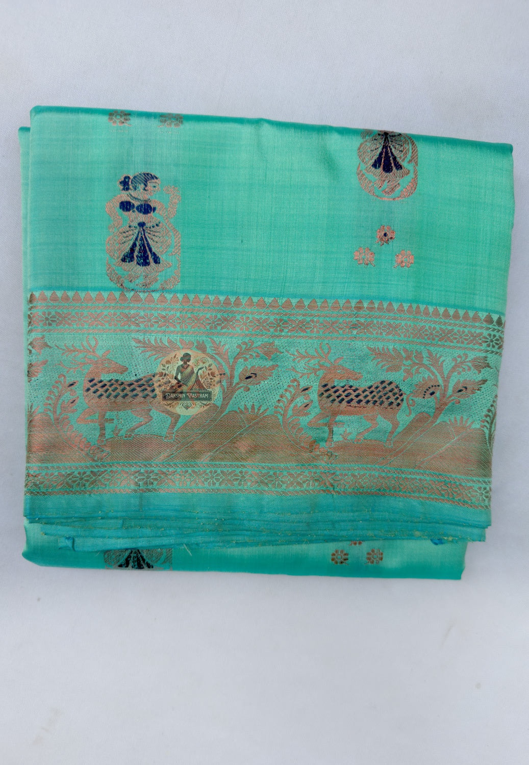 Close up of repeating motifs on the green Swarnachari silk saree body
