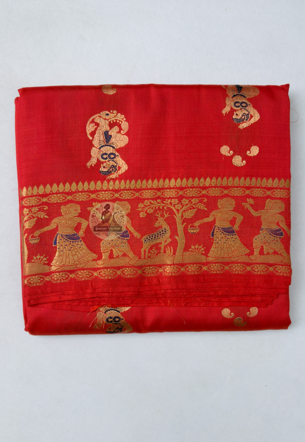 Close-up of Swarnachari handloom silk saree body showing warm silk texture with rhythmically spaced golden zari butis (small woven motifs), Bengal weave