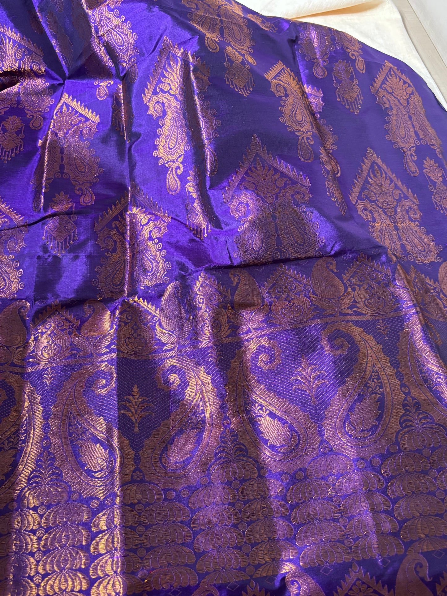 Close-up of handwoven peacock mayur and lotus pond border detail on Paat Mekhela Chador authentic Sualkuchi Assam mulberry silk craft
