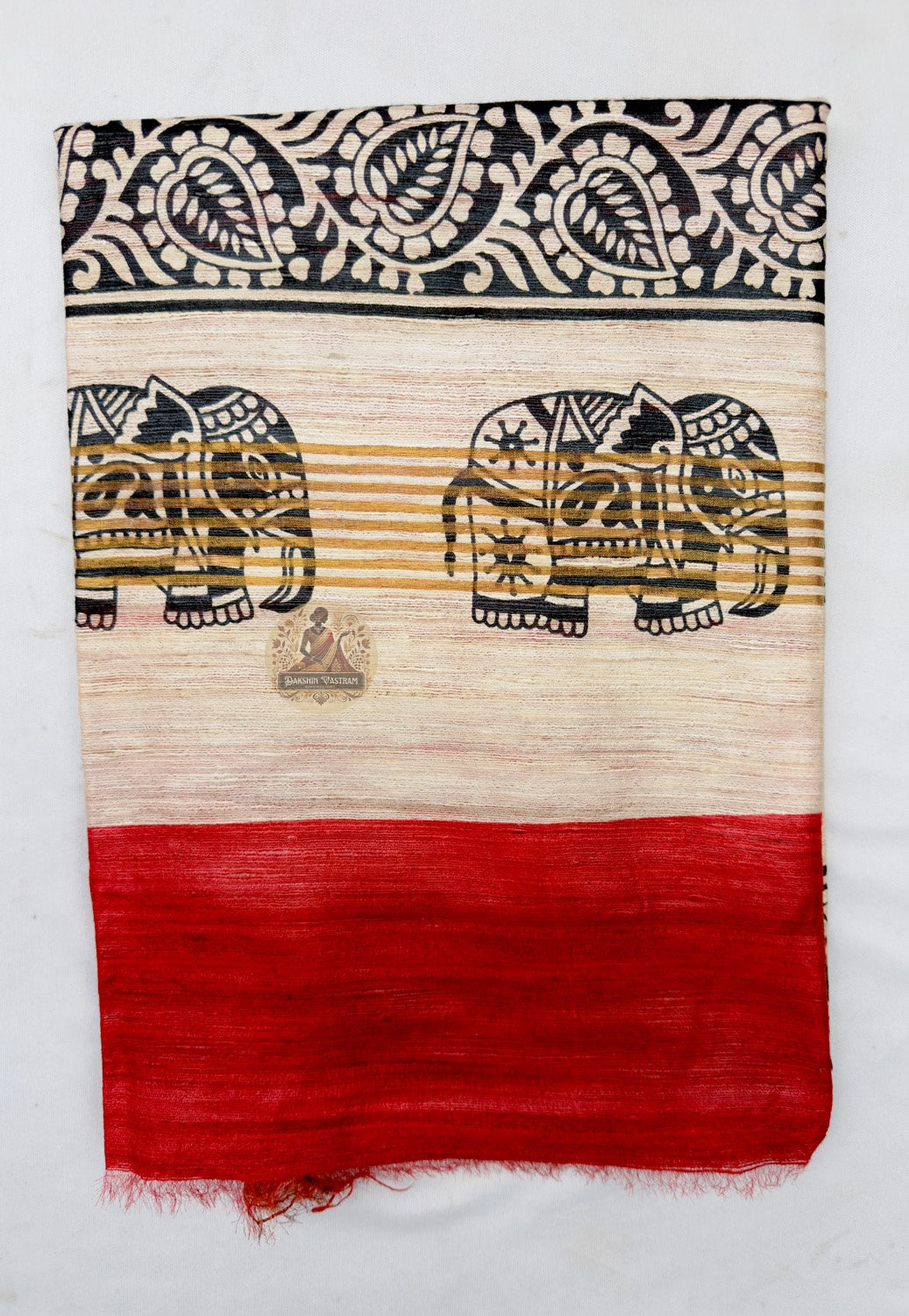 Close up of the broad black lower border featuring pale elephant motifs, fine stripes and gold-toned edging