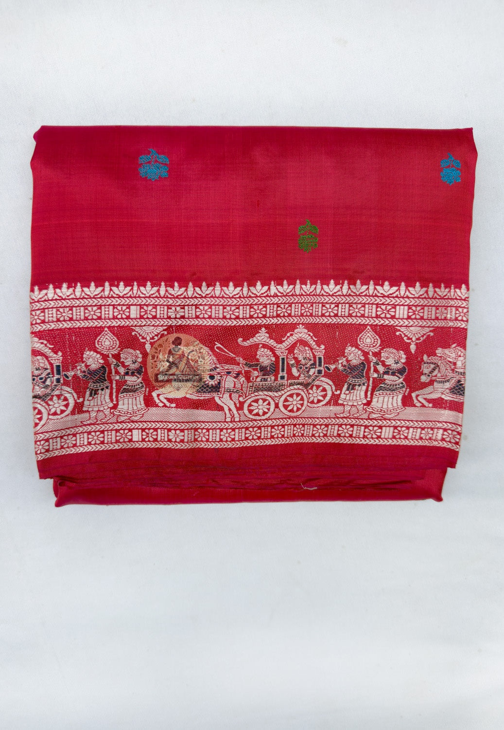 Full saree view highlighting cherry-red pleats, multicoloured motifs and the broad figurative pallu
