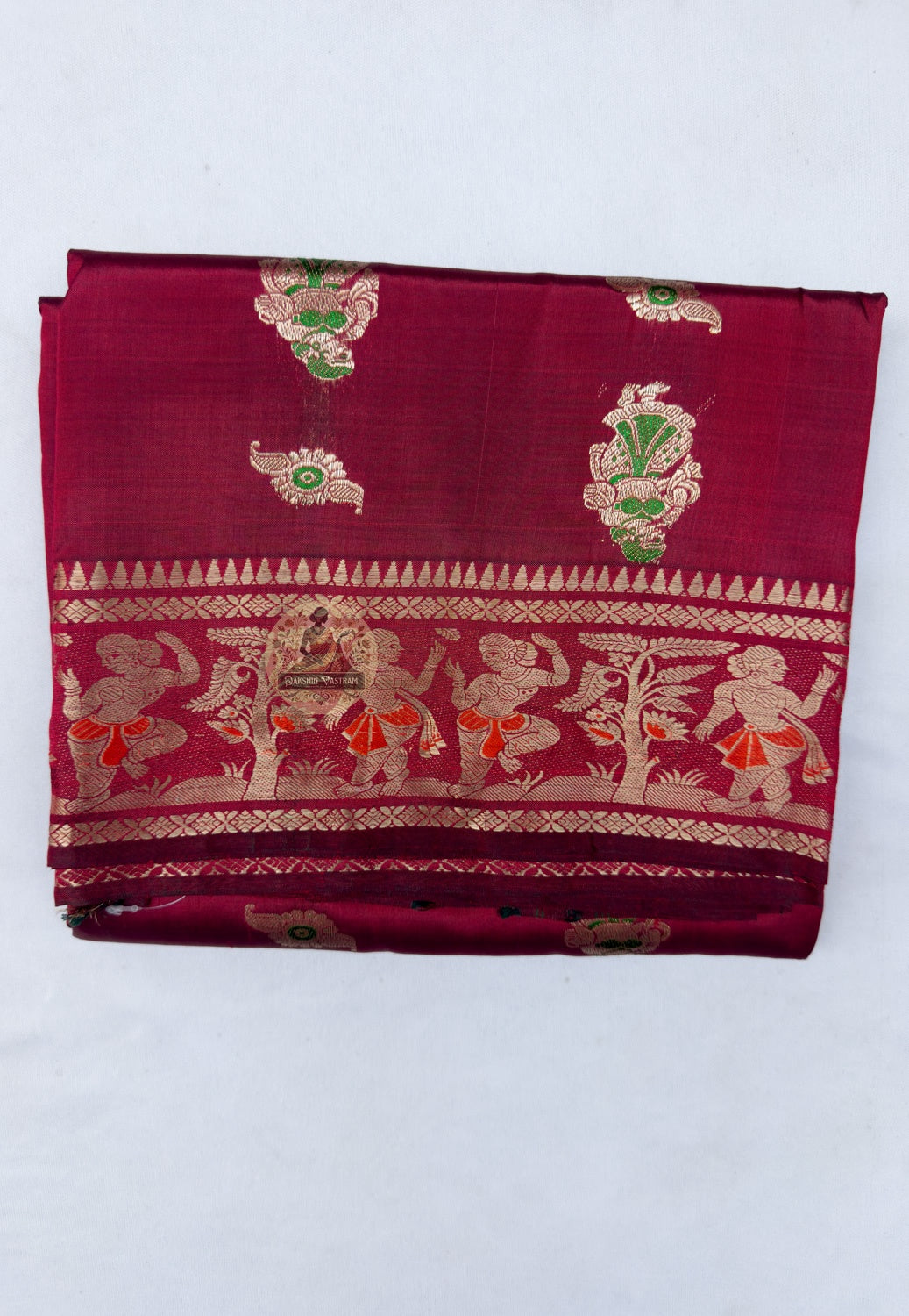 Close up of gold-toned woven motifs on the red Swarnachari silk saree body
