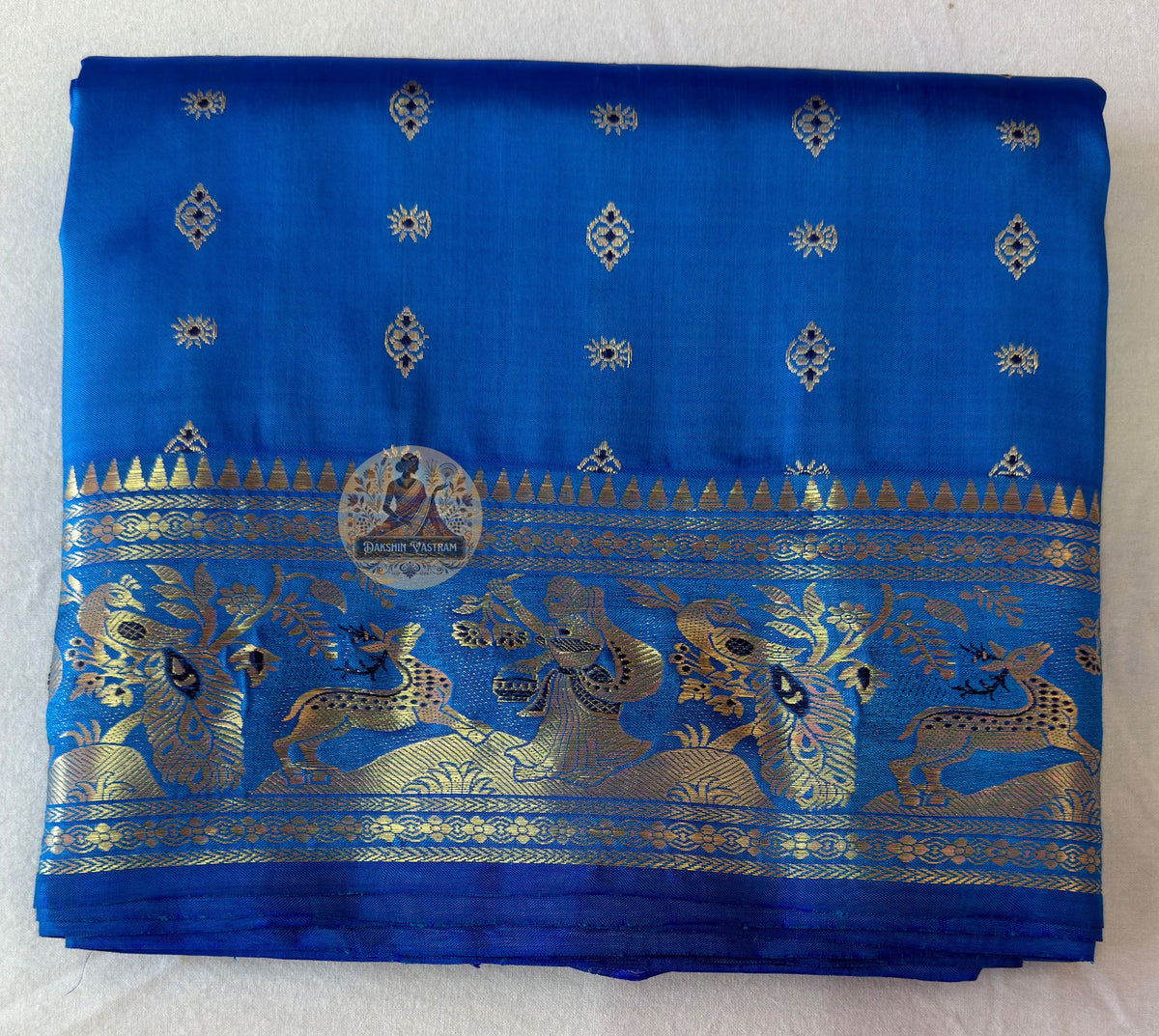 Rear view of blue Swarnachari silk saree showcasing fully expressed pallu with mythology and Bishnupur temple art golden zari compositions on deep indigo pure silk ground