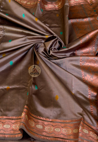 Close-up of heirloom Swarnachari silk saree pallu showing master-woven golden zari panel with figures in motion and Bengal temple frieze of exceptional precision