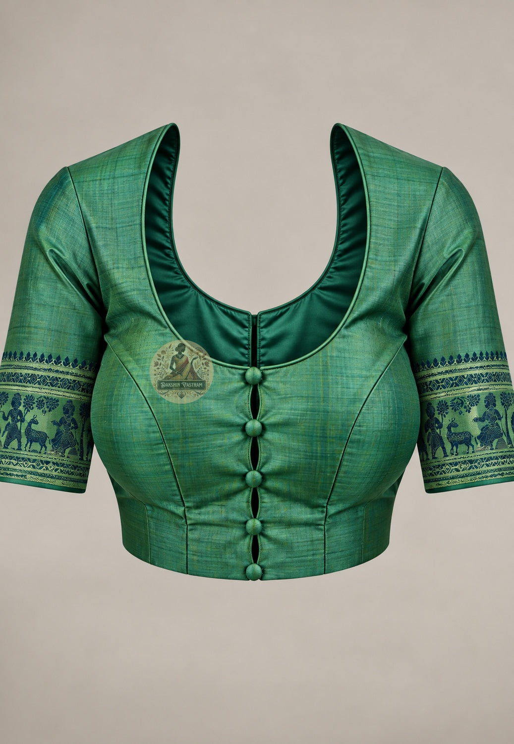 Blouse in matching green paired with the Baluchari silk saree and its blue woven motifs