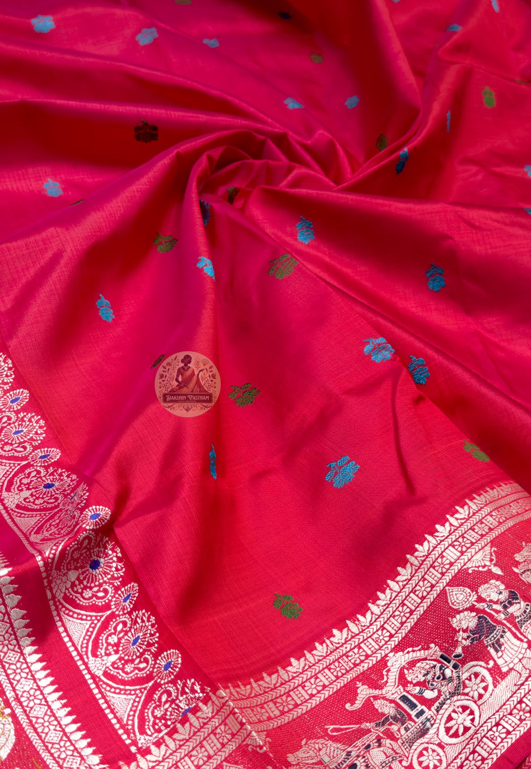 Full saree view of cherry-red Baluchari silk saree with pale borders and a detailed elephant pallu