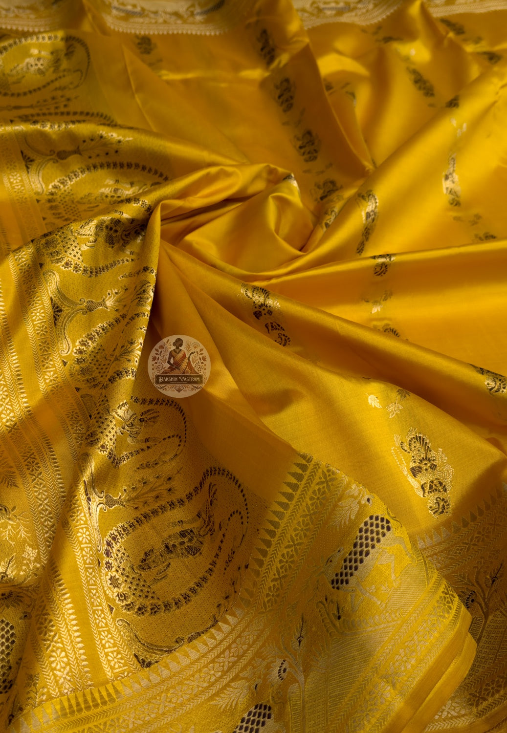 Close-up of handwoven silk weave on Swarnachari saree showing golden zari thread detail and natural lustre