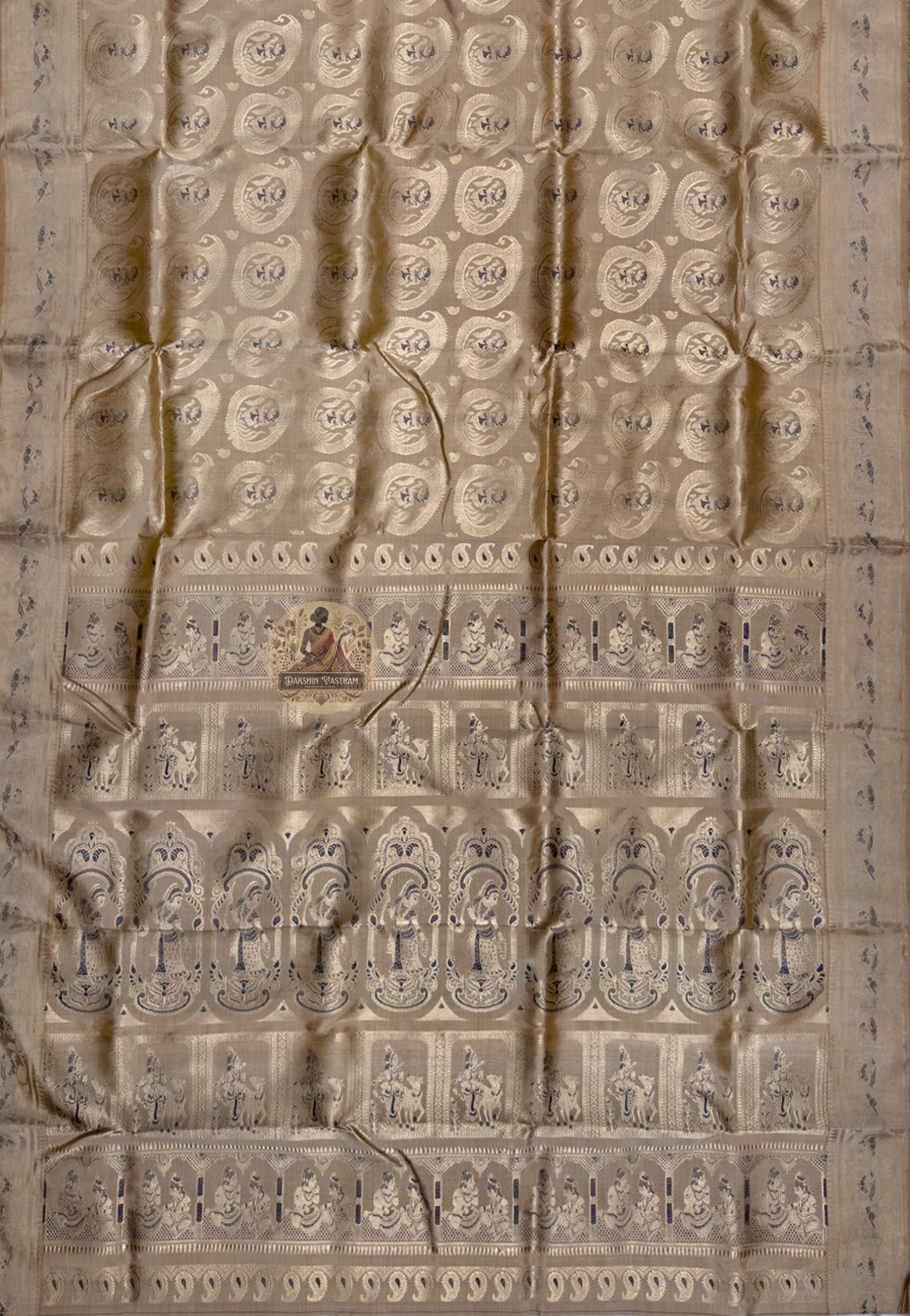 Close-up of premium Swarnachari silk saree pallu showing devotion-grade hand-woven golden zari with unified mythological scene and Bengal temple tradition motifs relating across the panel