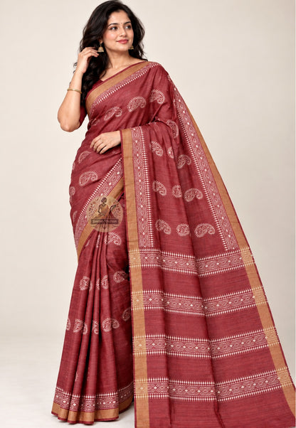 Front view of deep red Ghicha Tussar silk saree with pale paisley motifs and gold-toned borders