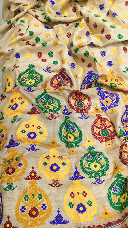 Front view of Assam handloom Muga silk saree with a golden-beige ground and multicolour floral motifs.
