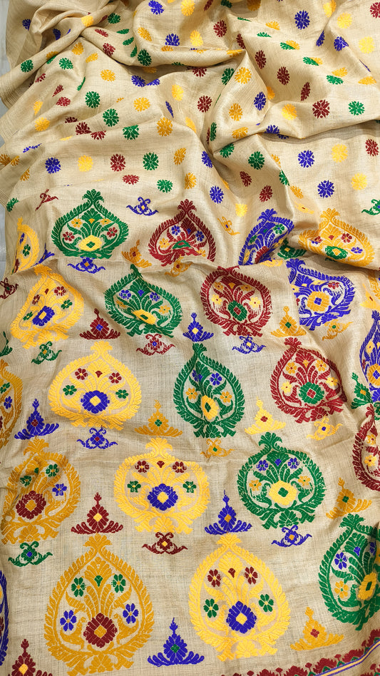 Front view of Assam handloom Muga silk saree with a golden-beige ground and multicolour floral motifs.