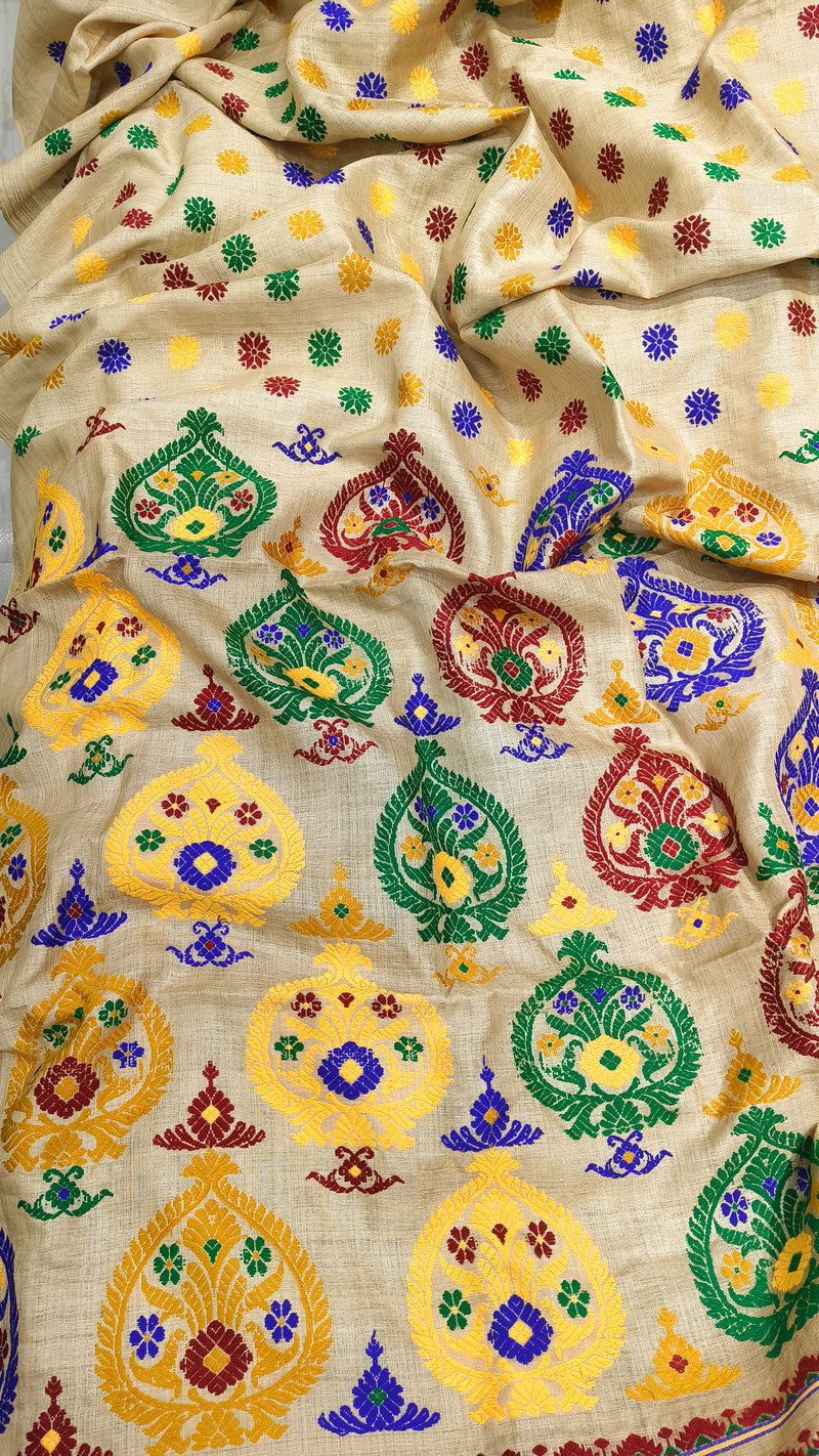 Front view of Assam handloom Muga silk saree with a golden-beige ground and multicolour floral motifs.