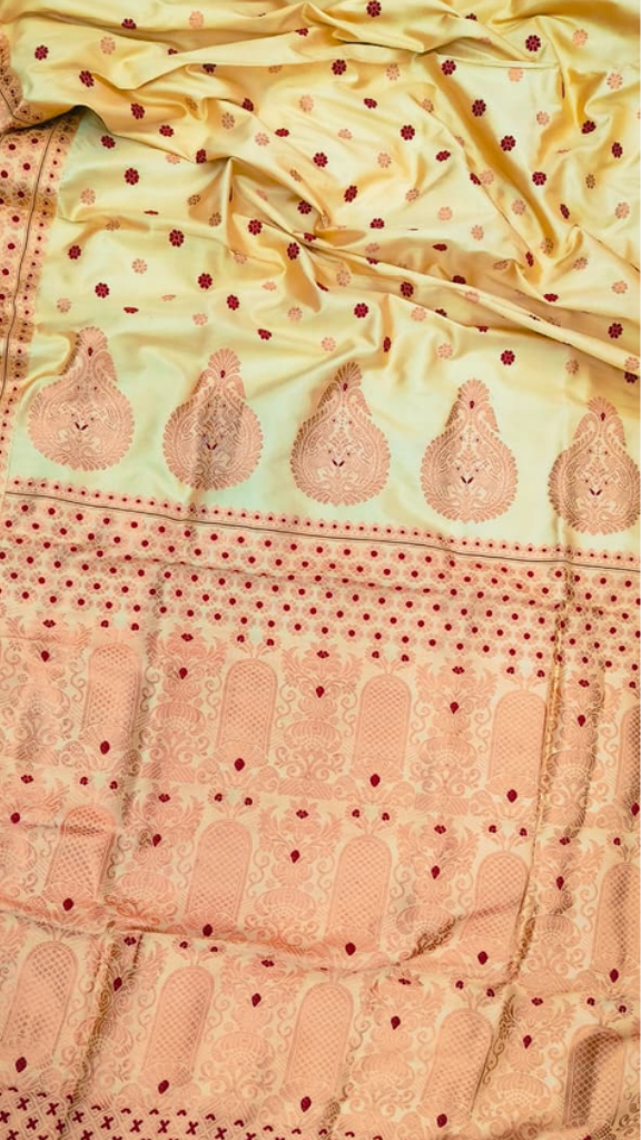 Front view of Assam Mulberry Silk Saree with copper zari work draped on model, showcasing the warm burnished metallic thread weave against luminous silk