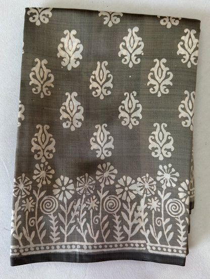 Close-up of Bishnupur Katan silk saree pallu showing hand block print composition with terracotta-inspired floral and figurative motifs pressed into pure silk using carved wooden blocks, Bishnupur West Bengal