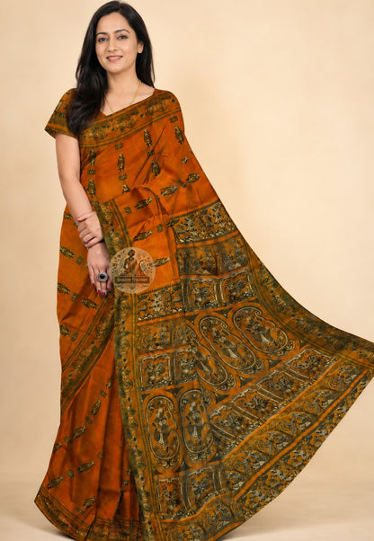 Mustard yellow Baluchari silk saree draped on model, showcasing the rich handwoven body with mythological motifs and elegant fall