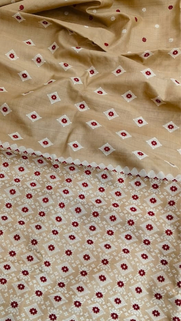 Side view of golden-beige Assam Muga silk saree with ivory geometric motifs and red floral accents.