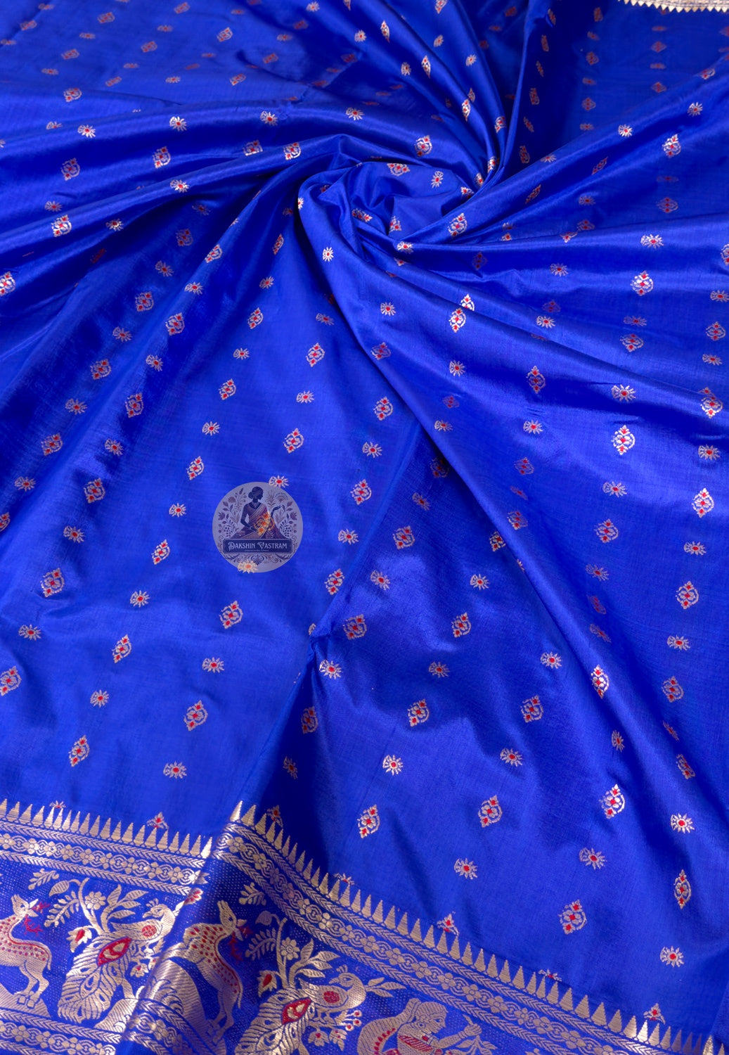 Rear view of royal blue Bishnupur Swarnachari saree showcasing richly woven gold zari pallu with mythological narrative scenes