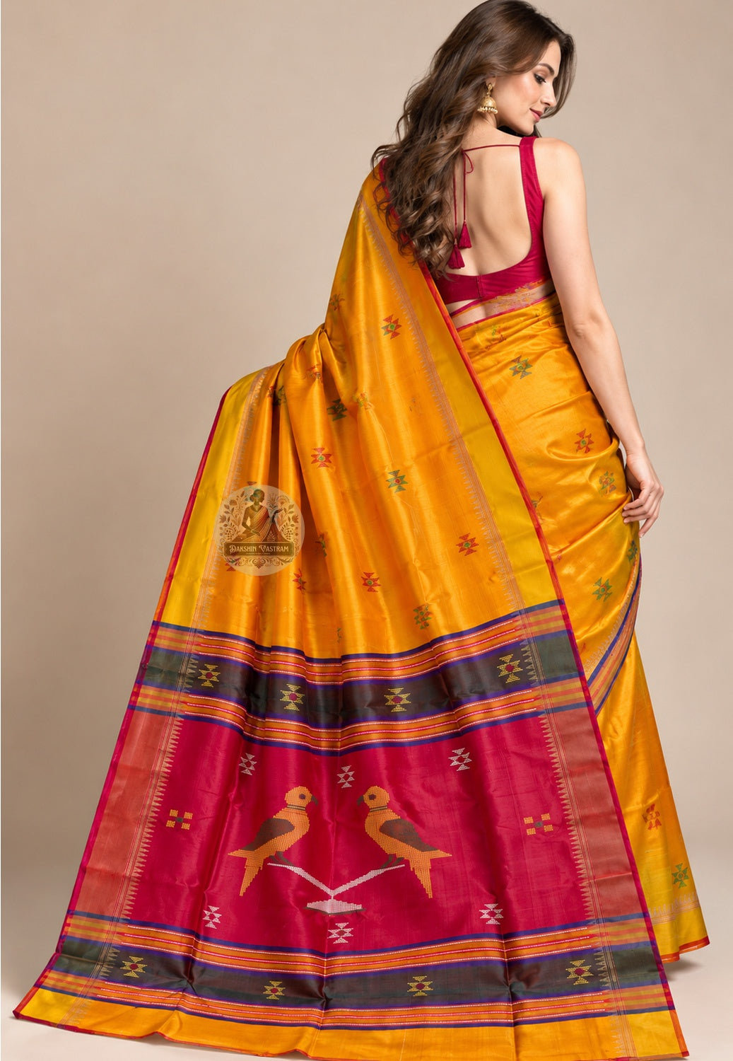 Side view of mustard-yellow Bishnupur silk saree showing the pleated drape and fine red edging
