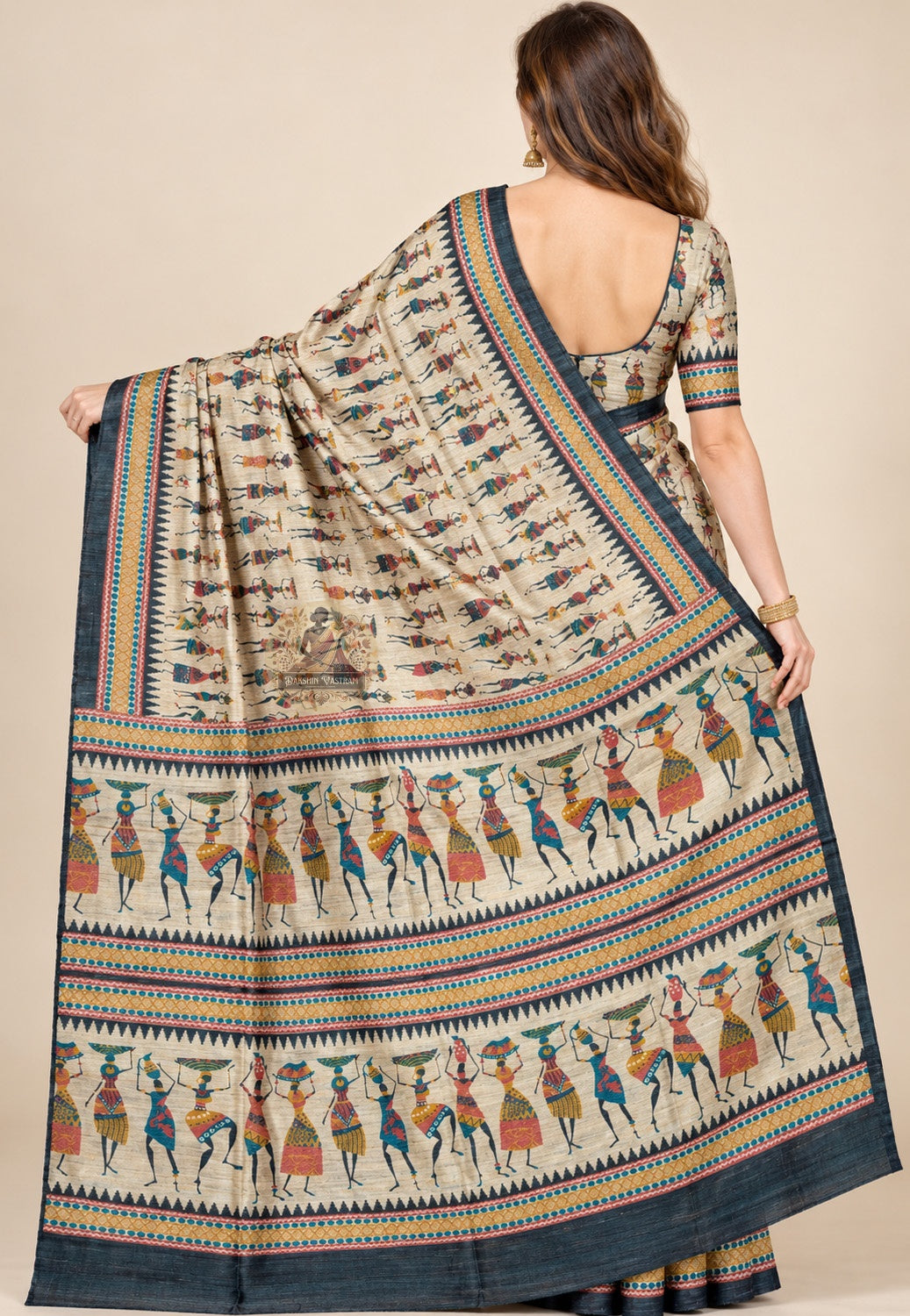 Rear view of beige Ghicha Tussar silk saree with the folk-figure pallu draped over the shoulder