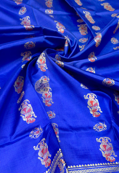 Close up of royal blue Baluchari silk saree pallu with rows of figures and large paisley panels
