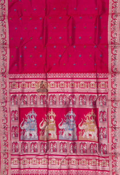 Close up of small blue and green motifs on the cherry-red Baluchari silk saree body