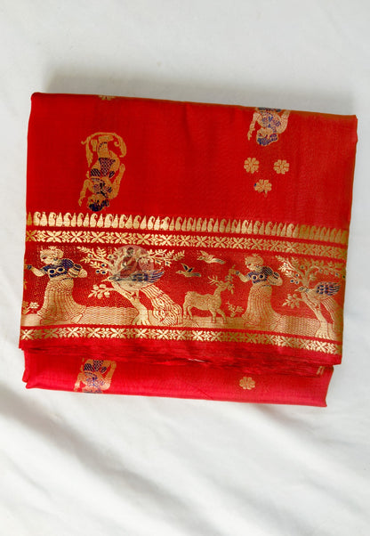 Close-up of Swarnachari silk saree weave showing golden zari Ramayana figures Malla court motifs and Bishnupur temple art patterns each communicating heritage knowledge in pure silk