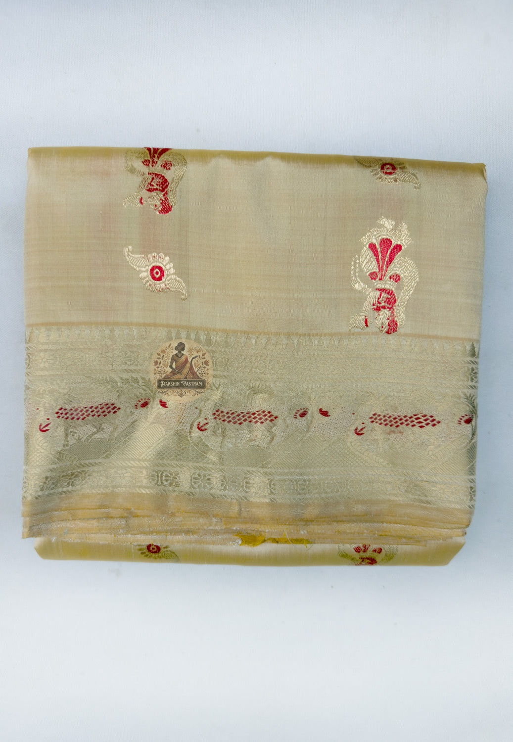 Close up of small red woven motifs on the beige gold Swarnachari silk saree body