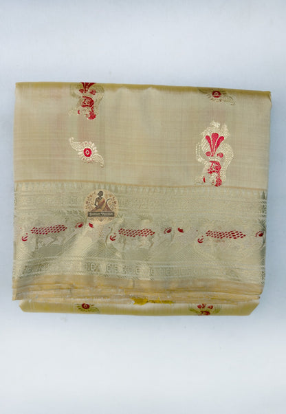 Close up of small red woven motifs on the beige gold Swarnachari silk saree body