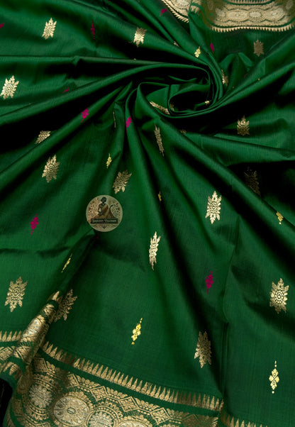 Close-up of Swarnachari silk saree pallu showing hand-woven golden zari witness panel with Bengal royal court figures and temple tradition scenes carried forward through generations of practice