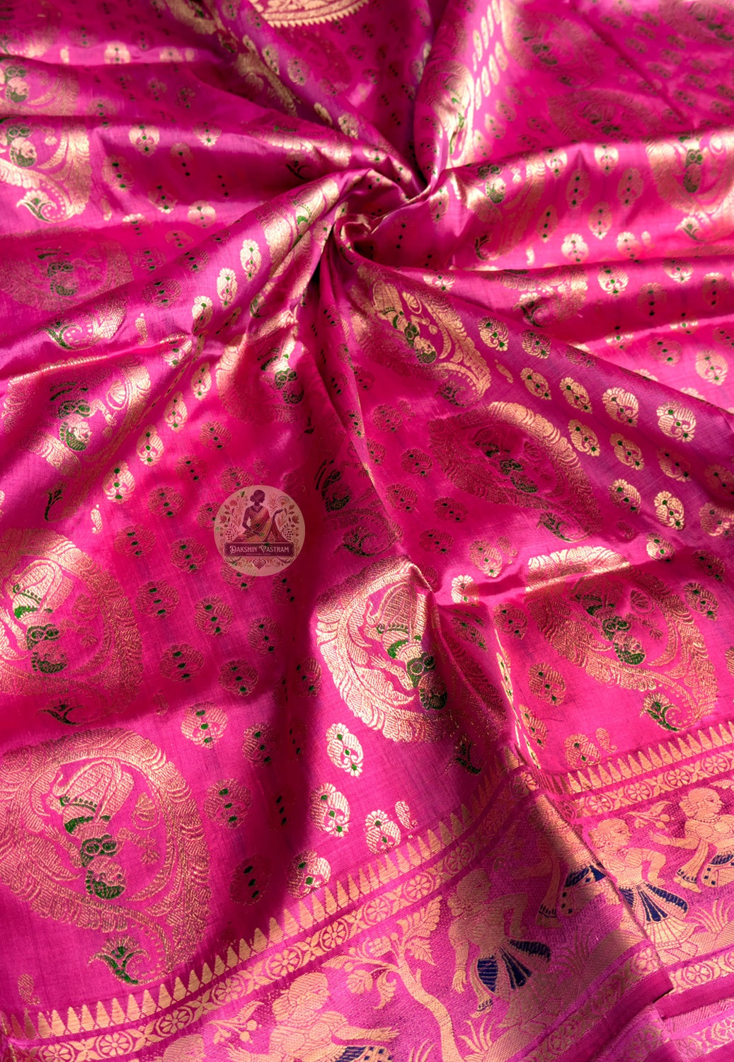 Close-up of premium Swarnachari handloom silk saree body showing warm pure silk ground with fine golden zari butis (small woven motifs) as details of a waiting story held precisely across the field