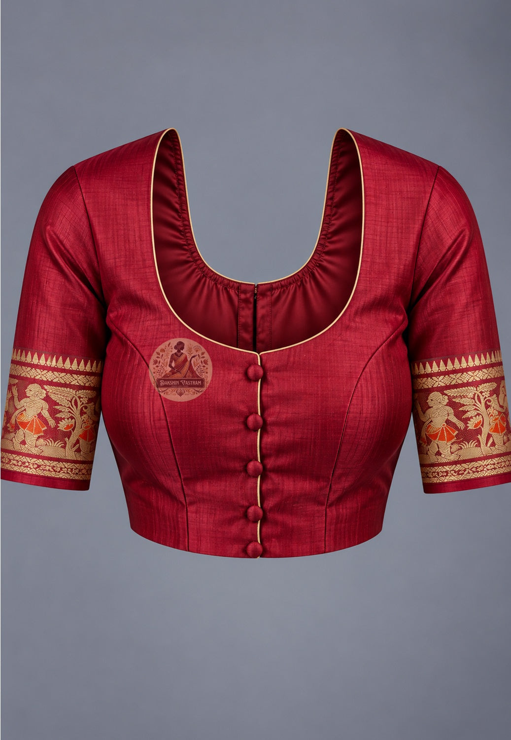 Blouse paired with red Swarnachari silk saree, featuring gold-toned motifs and patterned sleeve borders