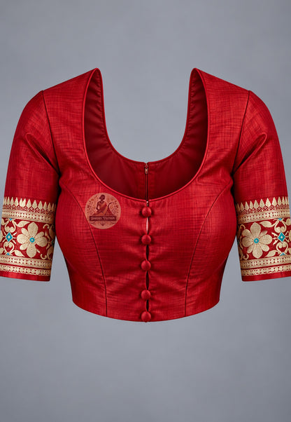 Blouse paired with maroon Baluchari silk saree, featuring a pale floral-patterned sleeve border