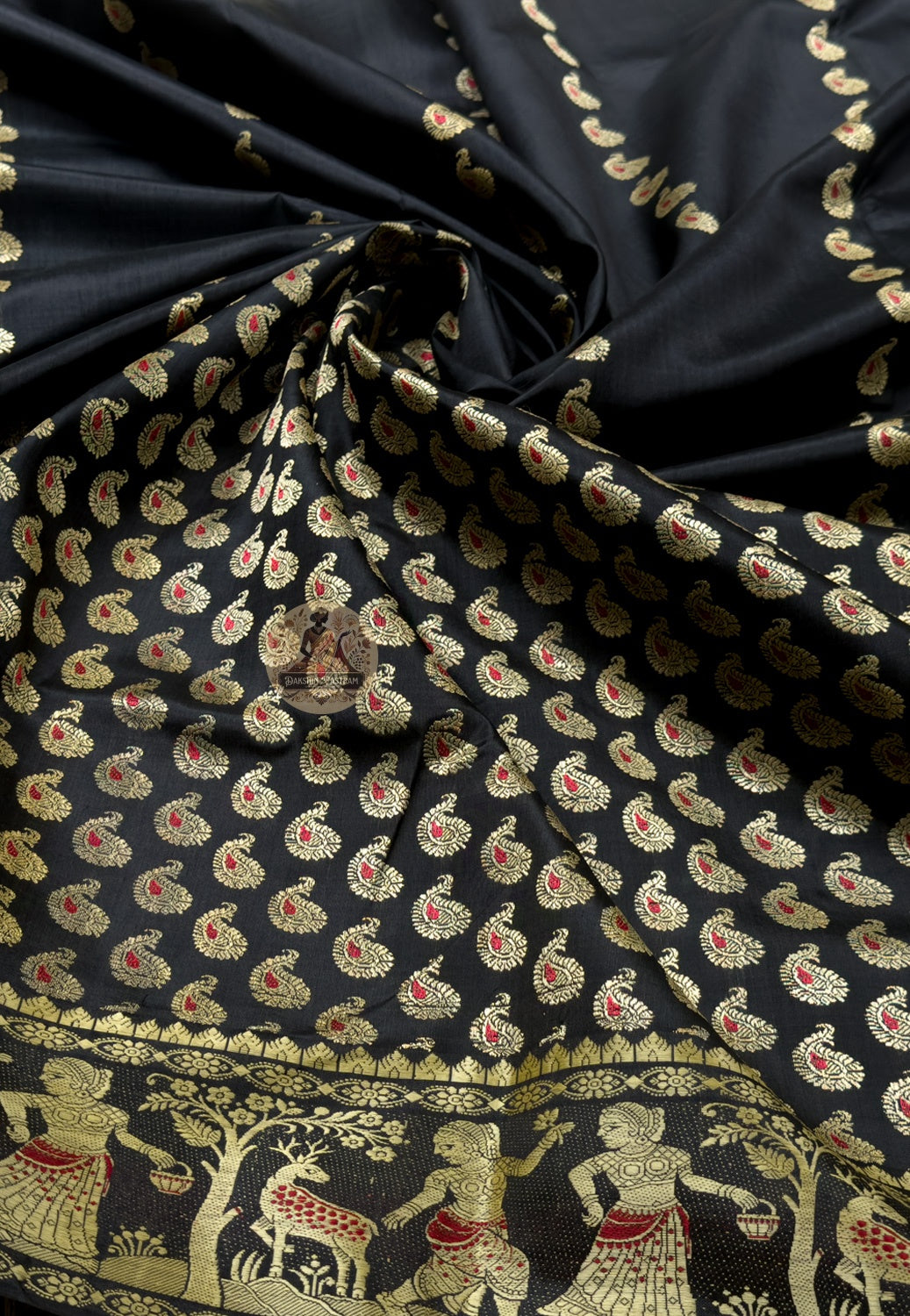 Close up of black Baluchari silk saree pallu with rows of figures and oval panels