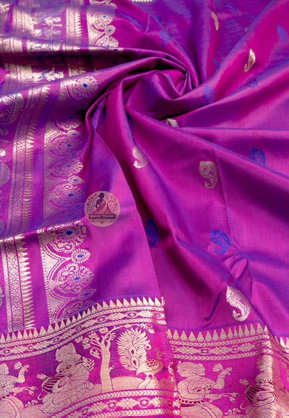 Full saree view of magenta Swarnachari silk saree with ornate borders and a figurative pallu