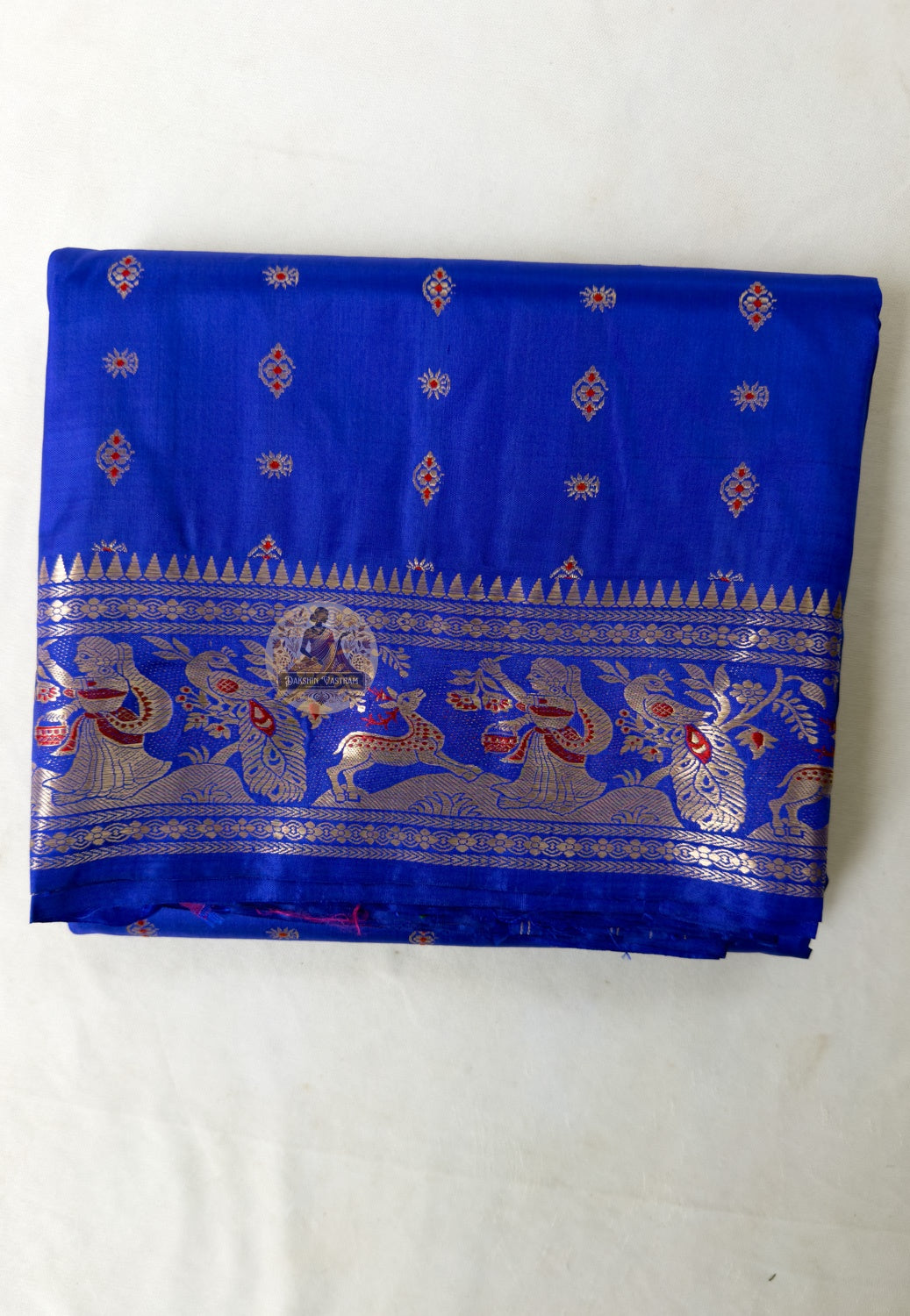 Close-up of pallu of Bishnupur royal blue Swarnachari saree showing dense gold zari narrative motifs woven by Bankura artisan weavers