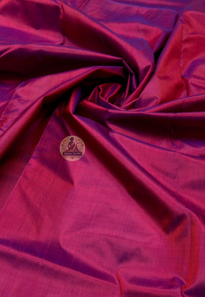 Close up of deep pink Bishnupur silk fabric with light reflecting across the folds