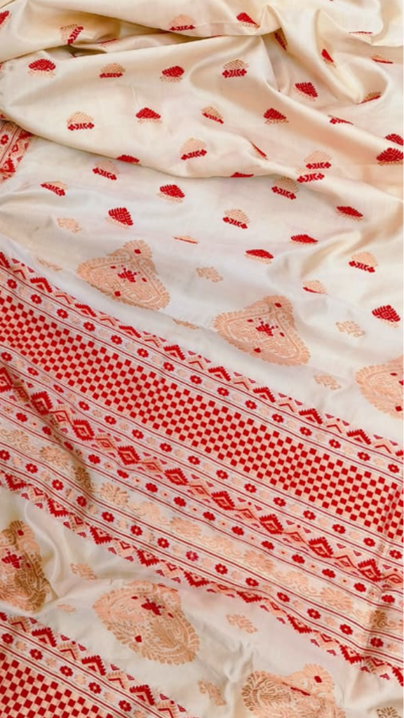 Close-up of running blouse fabric from Assam Mulberry Silk Copper Zari Saree set, featuring matching silk weave with warm copper metallic zari border