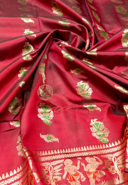 Close up of red Swarnachari silk saree pallu with woven figures, paisley panels and green accents