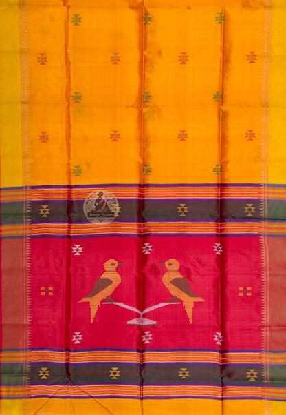 Close up of the red pallu featuring two stylised birds perched on a pale branch-like form