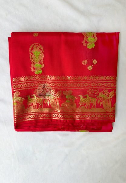 Full flat-lay of Swarnachari pure silk saree with golden zari recovery border, continued narrative pallu, rhythmic buti field, and matching unstitched blouse piece, West Bengal handloom