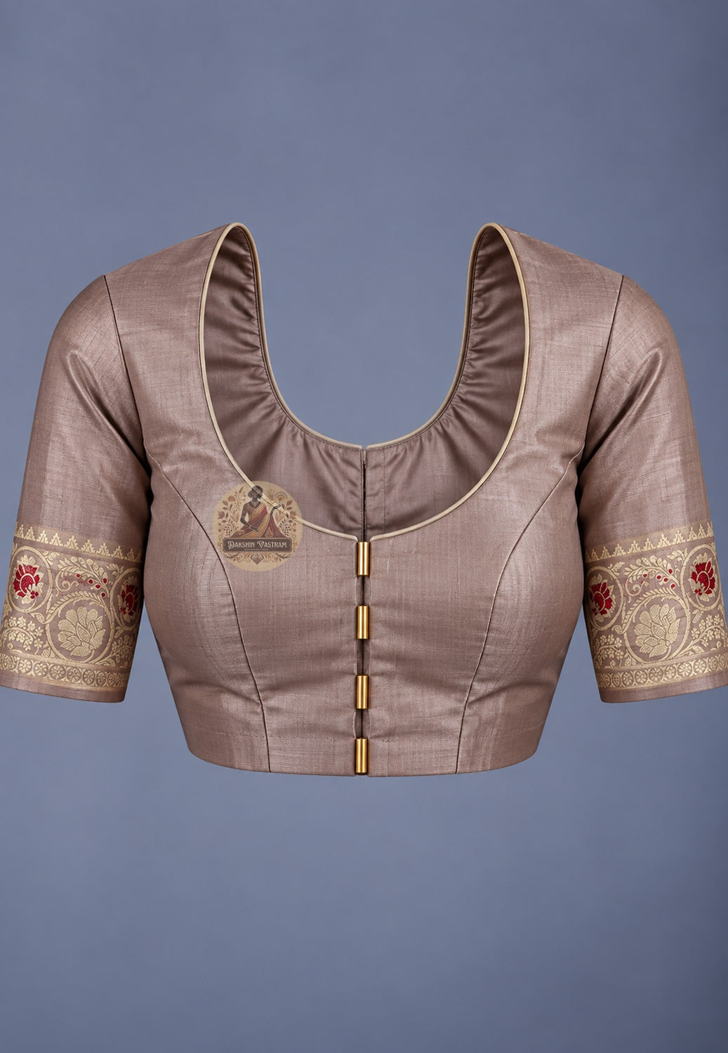 Blouse paired with beige Baluchari silk saree, featuring a scoop back and patterned sleeve borders