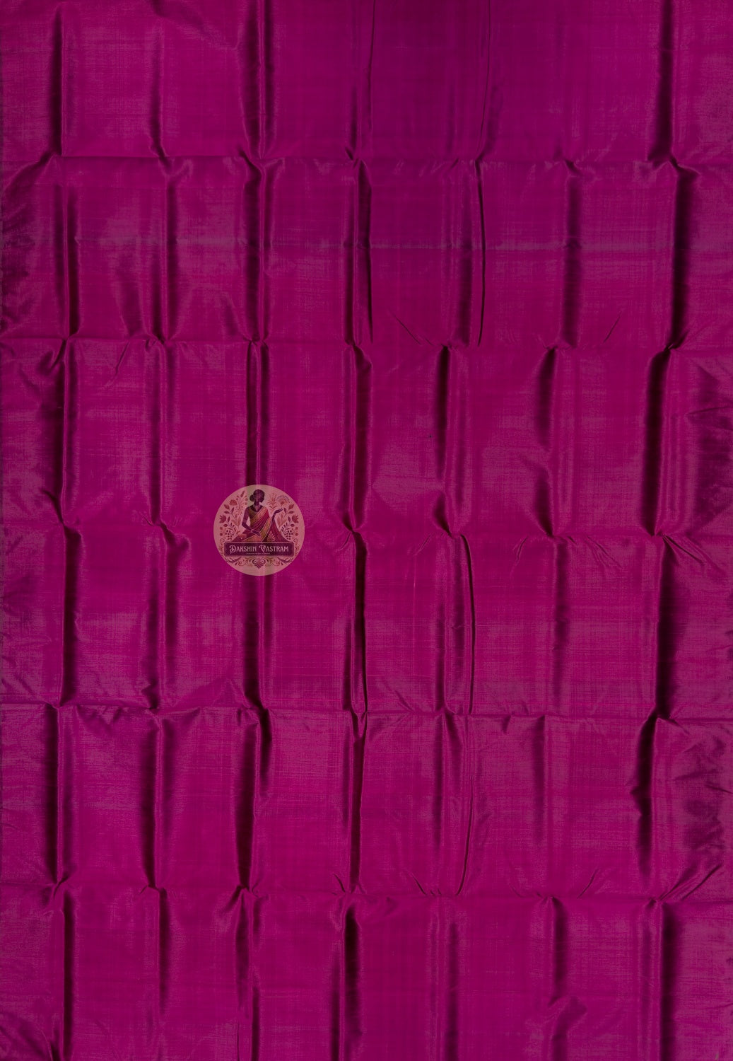 Close up of magenta Bishnupur silk fabric showing its sheen and subtle surface texture