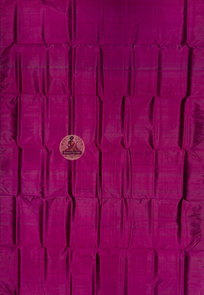 Close up of magenta Bishnupur silk fabric showing its sheen and subtle surface texture
