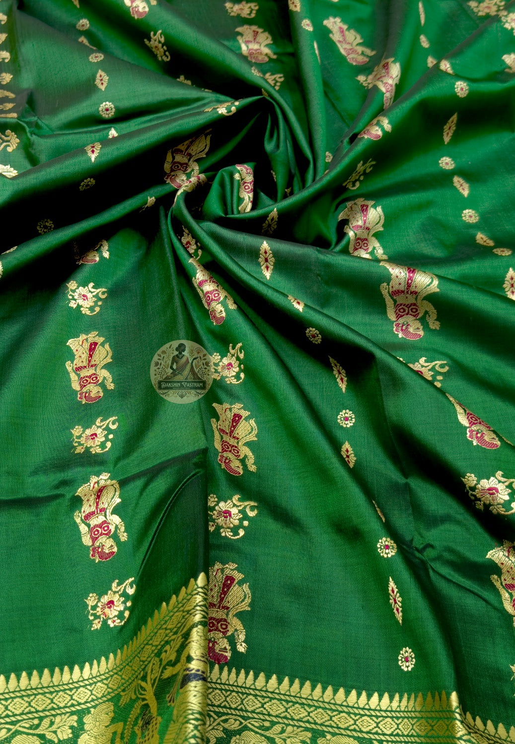 Close up of emerald green Baluchari silk saree pallu with figurative rows and large paisley panels