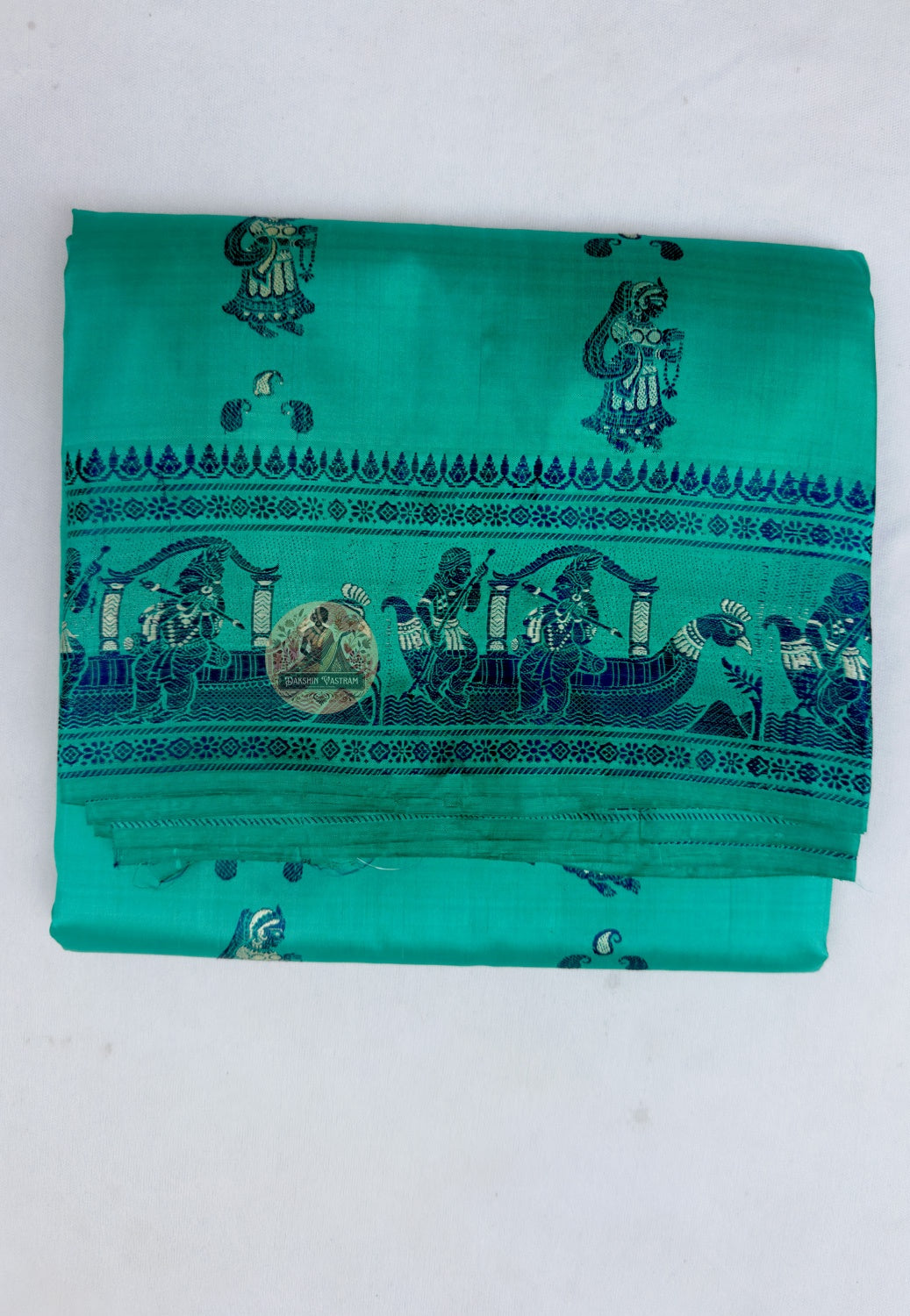 Close up of repeating woven motifs on the green Baluchari silk saree body
