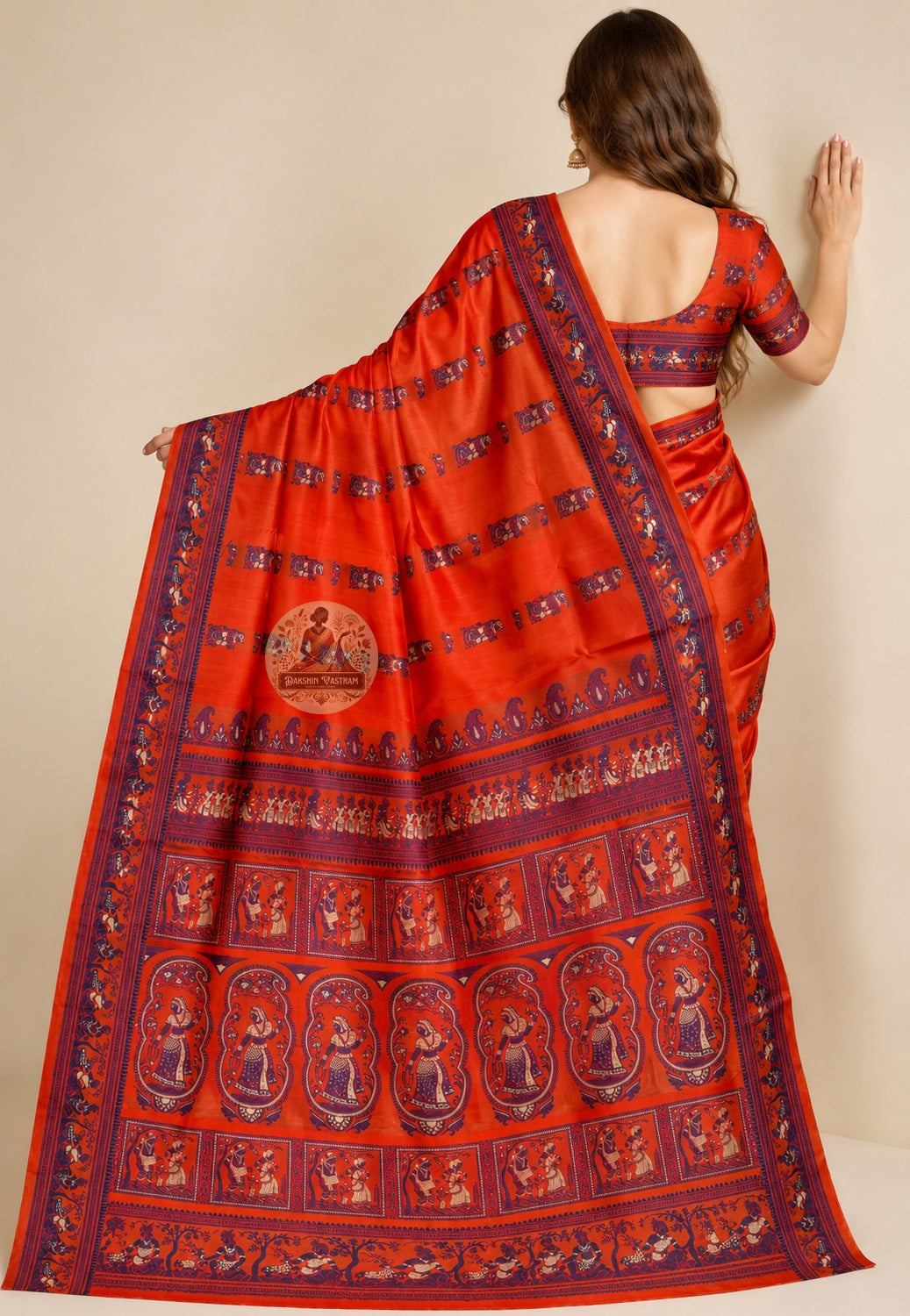Rear view of orange Baluchari silk saree with the figurative pallu draped over the shoulder